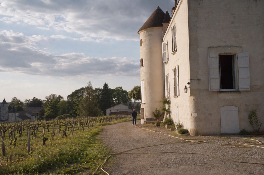 Chateau facade surrounded by vineyards on the edge of Saint Emilion, no text, no logos, no people